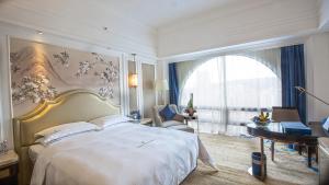Ένα ή περισσότερα κρεβάτια σε δωμάτιο στο Shenzhen Dayhello international Hotel (Baoan)