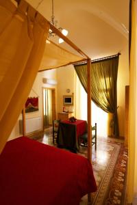 a bedroom with a red bed and a table at Olympo in Bisceglie