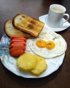 a plate of breakfast food with eggs and toast and a cup of coffee at Memory Lane in Colombo