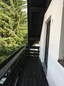 a balcony of a house with a wooden railing at Apartments Otašević in Kranjska Gora