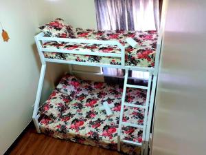 two bunk beds in a room with a bed at 516 Bristle Ridge 1209 Condo Unit Rental in Baguio
