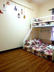 a bedroom with a bunk bed next to a staircase at 516 Bristle Ridge 1209 Condo Unit Rental in Baguio
