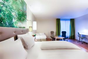 a bedroom with a white bed and a desk at ACHAT Hotel Bremen City in Bremen +24 photos