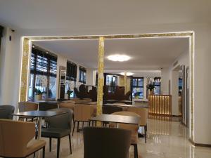 a restaurant with tables and chairs in a room at Hotel Aida Opera in Paris