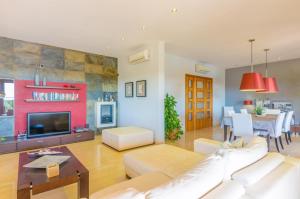 a living room with a white couch and a tv at Can Bou in Ses Salines