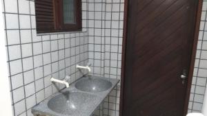 a bathroom with a sink and a mirror at Praia Apart Hotel in Natal