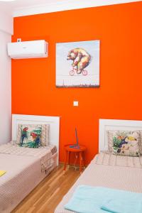 
a bedroom with a bed and a painting on the wall at Voula's Luxury Colored Apartment in Athens
