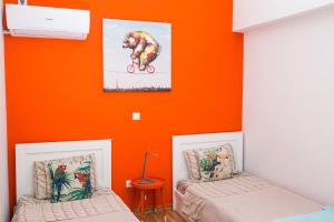 
a bedroom with a bed and a painting on the wall at Voula's Luxury Colored Apartment in Athens
