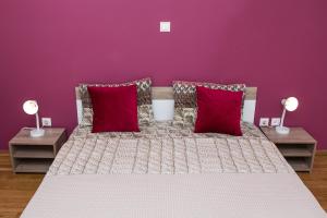 A bed or beds in a room at Voula's Luxury Colored Apartment