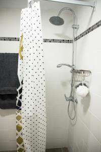 a bathroom with a shower with black and white polka dots at Diamerisma-Grafeio in Piraeus