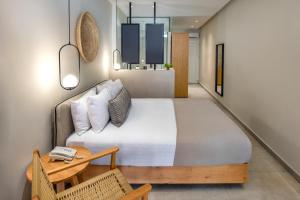a bedroom with a large bed and a table at Callia Retreat Suites - Adults Only in Fira