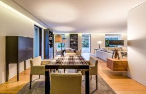 a dining room and living room with a table and chairs at Quinta de Merouço - Casa do Rio in Cotas