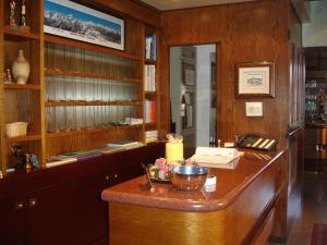 a room with a wooden counter with a desk at Hotel Adamello in Temù
