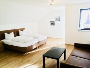 a living room with a bed and a couch at Gasthof Schrätzenstaller in Hettenshausen