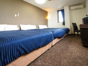 Voodi või voodid majutusasutuse HOTEL LiVEMAX BUDGET Gunma Numata toas
