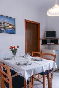 a dining room table with a white table cloth on it at Apartment Suzy in Vantačići