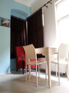 a white table and chairs in a room at TAXİM HOSTEL in Istanbul