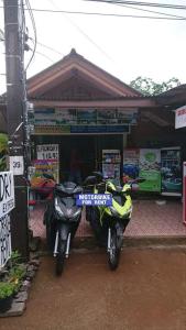 a motorcycle parked in front of a store at Lanta Valom Hideaway in Ko Lanta