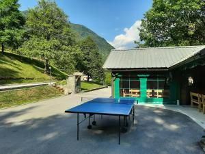 a ping pong table in front of a building at Apartments Reida in Most na Soči