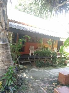 a house with a table and chairs in front of it at Lanta Valom Hideaway in Ko Lanta