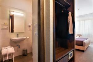 a small bathroom with a sink and a toilet at Hotel Raffaello in Florence