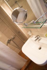 a bathroom with a white sink and a mirror at Olea Escape Villa in an Olive Estate in Gythio +73 photos