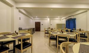 a dining room with tables and chairs at Treebo Arna Residency in Guwahati