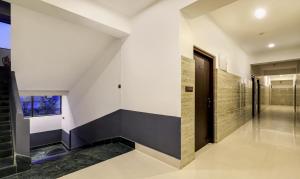 a hallway of a house with a black door at Treebo Arna Residency in Guwahati