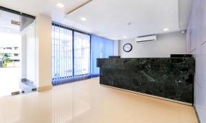 a lobby with a large black counter in a building at Treebo Trend Arna Residency in Guwahati