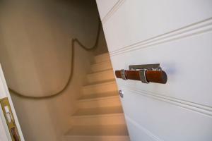 a stairwell with a white door and a spiral staircase at A Casa di LoLu in Grottammare