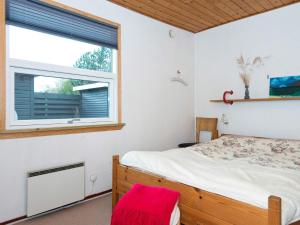 a bedroom with a bed and a window at 6 person holiday home in Hemmet in Hemmet