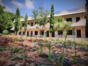 a building with trees in front of it at Rani Residency in Puducherry