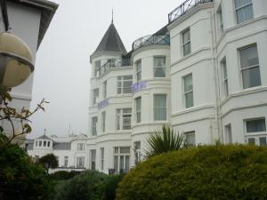 a large white building with a pointed roof at Royal Bath Hotel & Spa Bournemouth in Bournemouth