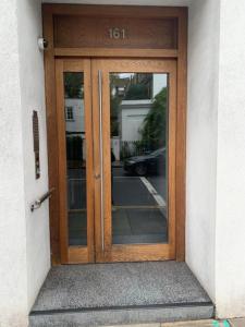 a wooden entry door to a building at Pond Place Apartments in London