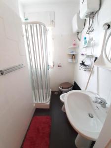 a bathroom with a white sink and a toilet at a due passi dal mare in Diamante +27 photos