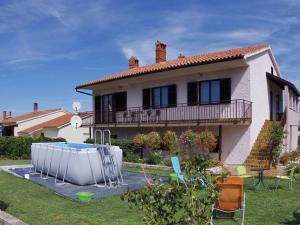 a house with a swimming pool in the yard at Comfortable and quiet apartment in Istria with privacy in Šajini