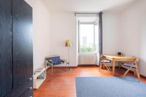 a room with a desk and a table and a window at Like At Home Piramide in Rome