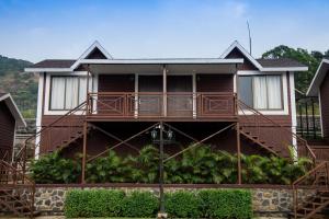 a house with a balcony on the side of it at Green Velvet Resort-Near Pawna Lake in Lonavala
