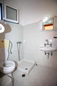 a bathroom with a toilet and a sink at Karidies in Skopelos Town