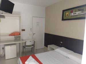 
A bed or beds in a room at Pousada Aquarela Do Brasil
