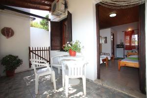 a patio with a table and chairs on a house at Karidies in Skopelos Town