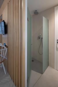 a bathroom with a shower with a glass door at L Anima Boutique Suites in Skiathos Town