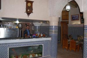 a kitchen with a counter with a fish tank at Hotel Jardin Public in Fez