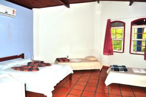 Katil atau katil-katil dalam bilik di Pousada Casa da Geleia