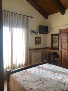 a bedroom with a bed and a large window at Agriturismo La Baita in Agerola