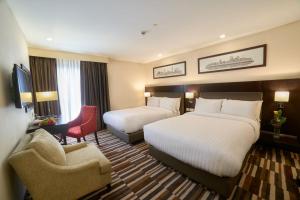 Avari Xpress Gulberg客房内的一张或多张床位