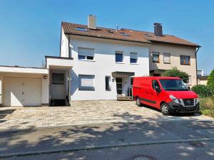 a red van parked in front of a house at My-Skypalace Neckarsulm in Neckarsulm