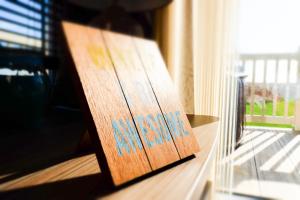 a wooden sign sitting on a table next to a window at Sea 'n' Stars Platinum Plus Holiday home with Views, Free Wifi and Netflix in Camber