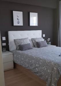 a bedroom with a large bed with two pillows at Piso MiraCíes- Wifi- Parking- Vistas Ría de Vigo in Vigo