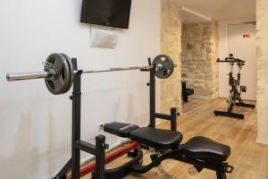 a room with a gym with two exercise bikes at Le 123 Sébastopol - Astotel in Paris